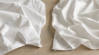 Crisp percale fabric beside smooth sateen fabric